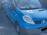 a blue van parked in a parking lot next to another van
