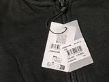 a black jacket with a tag on it and a barcode attached to it