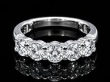 a close up of a diamond ring on a black surface