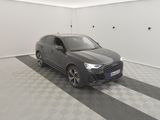 the grey car is parked in the garage on the checkered floor