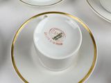 six cups and saucers with gold trims on a white table