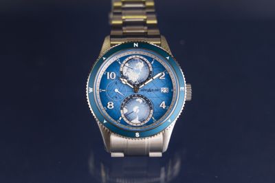a close up of a watch on a blue surface