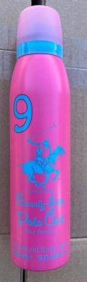 a pink bottle with a blue lid sitting on a tile floor