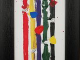 painting of multicolored stripes in a black frame on a wall