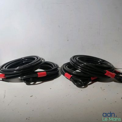 two black and red cables sitting next to each other on a table