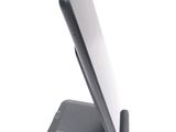 a cell phone that is on a stand on a white surface