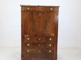 an old wooden chest of drawers with brass hardware on the top