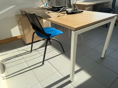 a desk with a chair and a computer monitor on it