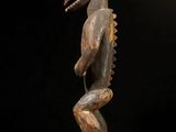 a wooden statue of a man with a bird on his head