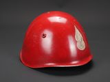 a close up of a red helmet on a black background