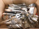 a box full of silver spoons and spoons in it