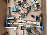 a cardboard box filled with assorted construction tools