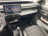 the interior of a car with a steering control and dashboard controls