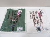 two bags of t - shirts that are on a table