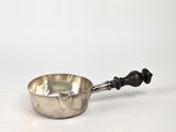 une casserole ancienne en argent avec un manche en bois, sur fond blanc