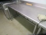a metal counter top in a kitchen with a sponge on it