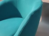a blue chair that is sitting on a white table