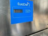 a blue sign on the side of a stainless steel refrigerator