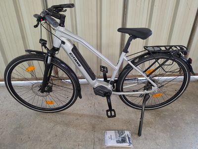 a bike parked next to a book on the floor