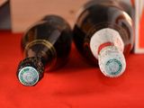 two bottles of beer sitting on a red table