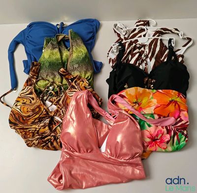 several different types of women ' s swimsuits laid out on a white surface