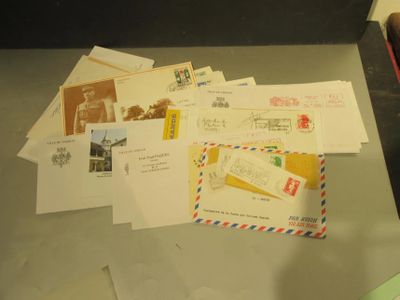 a pile of mail sitting on a table next to a pair of scissors