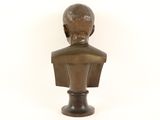 bronze bust of a boy on a pedestal on a white background