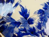 a blue and white plate with a flower design on it