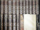 a lot of books that are stacked on top of each other