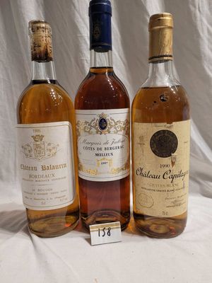 three bottles of wine are lined up on a table