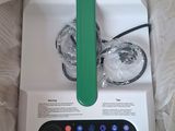 a white and green blender in a box with a green handle