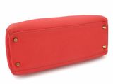 the large red purse is sitting on a white surface