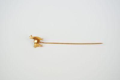 a small piece of gold on a white surface