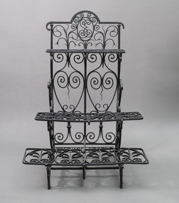 a black metal shelf with three shelves on top of it