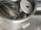 a bowl with a whisk inside of it on a counter