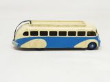 a toy bus that is sitting on a white surface