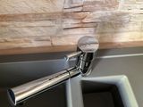 a faucet that is attached to the side of a sink