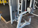 a gym room with a row of machines in it
