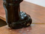 a statue of a hand holding a cell phone on a table