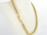 a gold beaded necklace on a mannequin mannequin mannequin mannequin mannequin mannequin mannequin mannequin mann