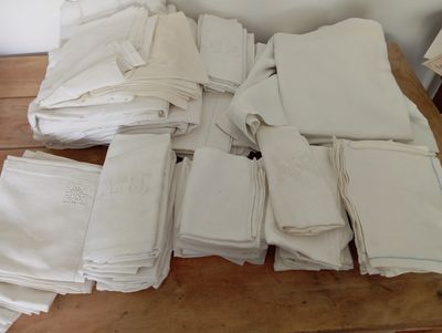 a pile of folded white towels on a wooden table
