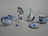 a group of blue and white vases and other items