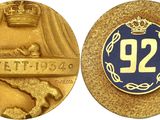 a close up of a gold medal with a crown on it