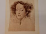 an old photo of a woman with curly hair in a white frame