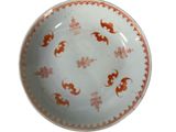 a white plate with orange designs on it