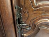a close up of a door handle on a wooden door