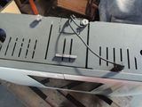 a small oven with a metal cover on top of it