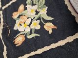 a black rug with a floral design on it