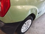 a green car that is parked in a garage