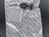 a package of screws in a plastic bag on a table